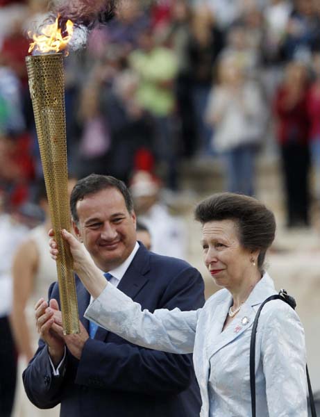 The flame for the London Olympics, which will start on July 27 after a 70-day torch relay around Britain, was handed over on Thursday at a damp ceremony in the marble stadium that hosted the first modern Games in 1896. London receives flame in rainy Athens