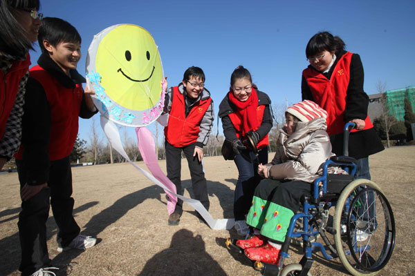 Students from Beijing University of Chemical Technology took disabled children kite-flying in Chaoyang district, hoping to inspire the kids to pursue their life's desires. Chen Xiaogen / for China Daily  Volunteering not voluntary