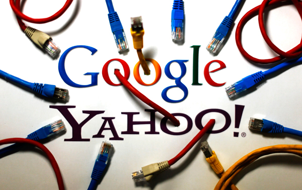 An illustration picture shows the logos of Google and Yahoo connected with LAN cables in a Berlin office October 31, 2013.  NSA scoops data secretly from Yahoo, Google