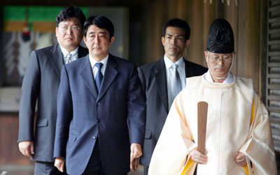 Shinzo Abe (2nd L), Japan's Chief Cabinet Secretary and front-runner to become Japan's next prime minister, is led by a Shinto priest as he visits the controversial Yasukuni Shrine in Tokyo to pay tribute to the war dead in this August 15, 2005 file photo. Abe made a secret pilgrimage earlier this year to the Tokyo war shrine seen by China and South Korea as a symbol of Japan's past militarism, media reports said on 4 August, 2006.