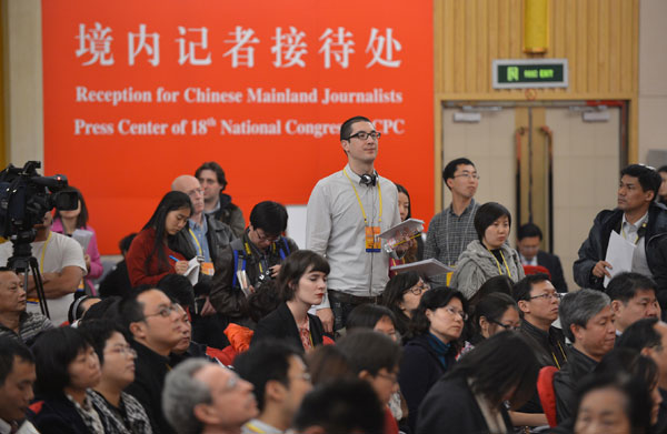 Reporters from home and abroad at a news conference for the 18th National Congress of the Communist Party of China in Beijing. Li Xin / Xinhua  Leadership change evokes positive reaction