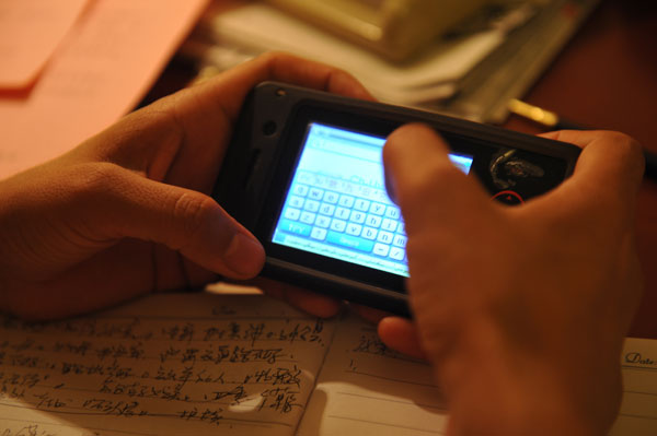 Rehangul Yimir translates her proposal into mandarin from the Uygur language with the aid of an electronic translator. Photos by Cui Jia / China Daily Newcomers get chance to shine under NPC spotlight