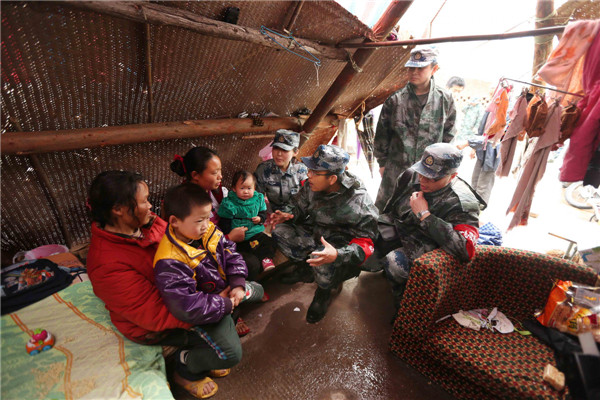 A psychological expert speaks to children after the quake to prevent post traumatic stress in Longmen township, Ya’an city, Sichuan province April 23, 2013. Shaking off the mental horrors of the quake
