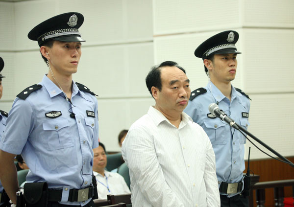 Lei Zhengfu, a former official of Chongqing's Beibei district, stands trial on June 19 in a court in the city.  Chongqing ex-official gets 13 yrs