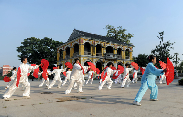 Residents in Guangzhou exercise on a square, May 1, 2012. Group dancing limited in S China