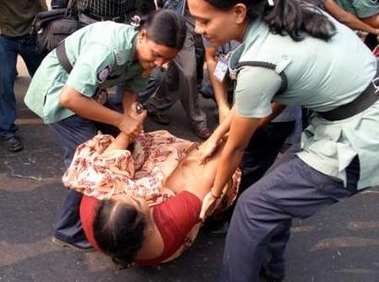 Bangladesh police drag an opposition activist away during a general strike in Dhaka November 24, 2005.