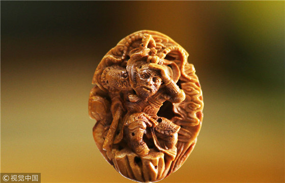 Carving the world on a peach pit