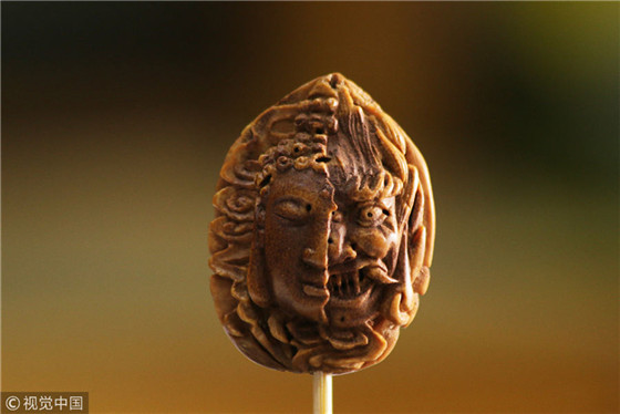 Carving the world on a peach pit