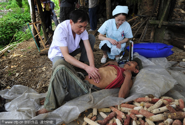 Chen Dejun receives medical check-up in his cottage in Chongqing, July 11, 2011. Man drinks gasoline for 42 years