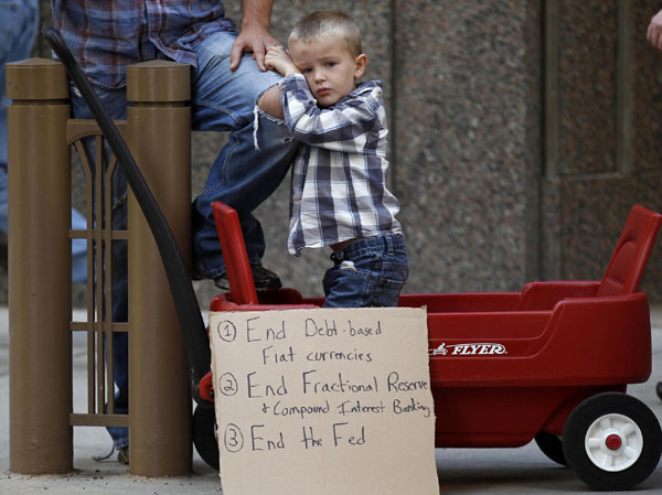 Lincoln Hallgren joins his father during a demonstration in support of the New York Occupy Wall Street protests in front of the Chicago Board of Trade Building in the financial district of Chicago, October 5, 2011. US 'occupied' by protestors
