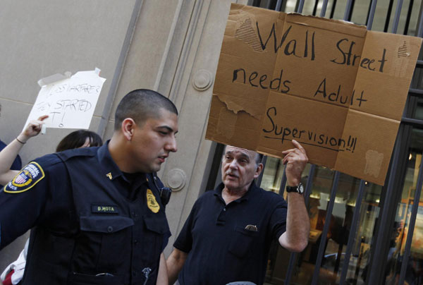 A protestor demonstrates in support of the New York Occupy Wall Street protests in front of the Federal Reserve Bank of Chicago in the city's financial district, October 5, 2011. US 'occupied' by protestors