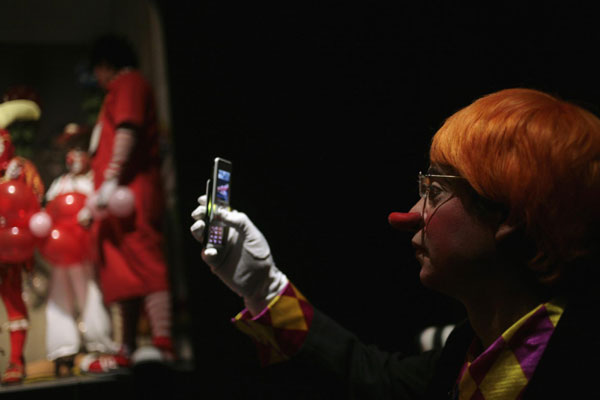 A clown takes a picture with his phone during the sixteenth international clown convention in Mexico City Oct 17, 2011. Int'l clown convention held in Mexico