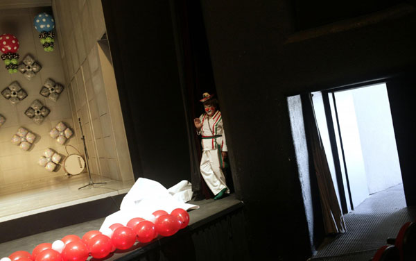 A clown stands next to the stage during the sixteenth international clown convention in Mexico City Oct 17, 2011. Int'l clown convention held in Mexico