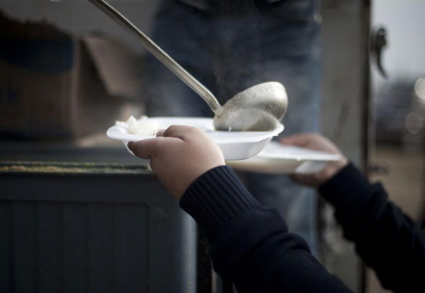A member of a charity organization serves an afternoon meal to an earthquake victim at a stadium currently used as a relief shelter campsite in Ercis Oct 26, 2011. Turkey struggles to shelter people after quake
