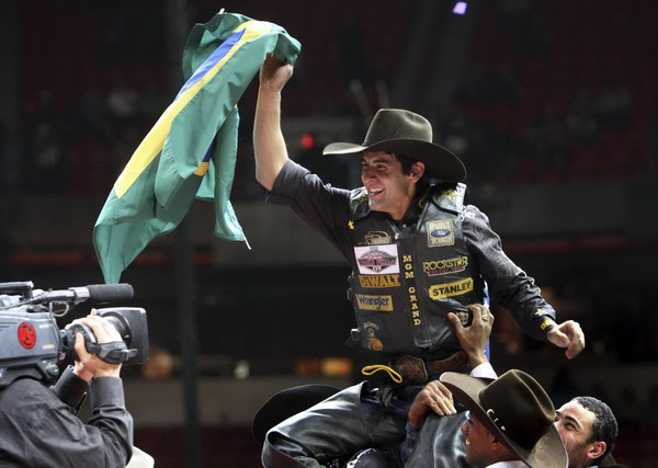 Brazilian bull rider Silvano Alves waves the flag after winning the season championship and $1million at the Professional Bull Riders World Finals in Las Vegas, Nevada Oct 30, 2011. Brizilian bull rider wins PBR world finals