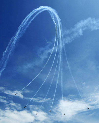 Royal Australian Air Force (RAAF) Roulettes aerobatic display team performs with their Pilatus PC-9 aircrafts during an aerial display at the Singapore Airshow in Singapore February 16, 2012. Singapore holds largest airshow in Aisa