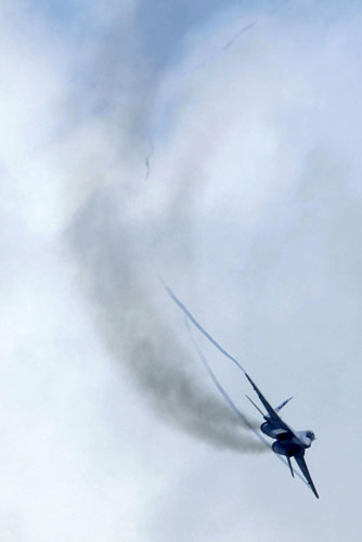 A MiG-29N 'Fulcrum' fighter aircraft of the Royal Malaysian Air Force (RMAF) 'Smokey Bandits' aerobatic display team flies during an aerial display at the Singapore Airshow in Singapore February 16, 2012. Singapore holds largest airshow in Aisa