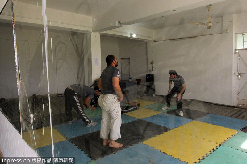 A picture taken on Feb 27, 2013 shows Iraqis stretching during a parkour training in the Iraqi capital Baghdad. Public sports in post-war Iraq