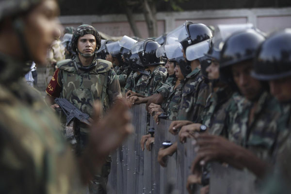 Army soldiers take their positions in front of protesters who are against Egyptian President Mohamed Mursi, near the Republican Guard headquarters in Cairo July 3, 2013. Jubilant crowds celebrate after Morsi overthrown