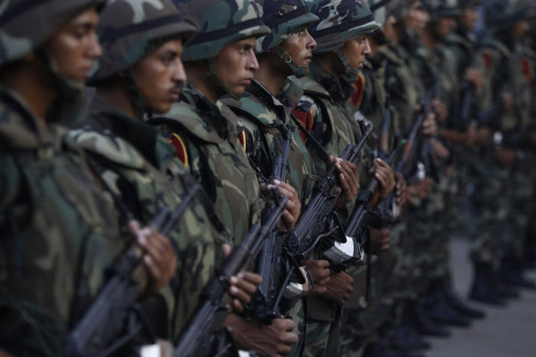 Army soldiers take their positions in front of protesters who are against Egyptian President Mohamed Mursi, near the Republican Guard headquarters in Cairo July 3, 2013. Jubilant crowds celebrate after Morsi overthrown