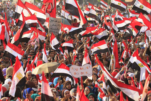 Protesters, who are against Egyptian President Mohamed Mursi, wave the Egyptian national flag as they gather at Tahrir Square in Cairo July 3, 2013. Jubilant crowds celebrate after Morsi overthrown