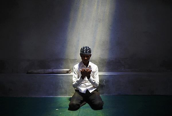 A Nepalese Muslim boy offers Friday prayers during the Muslim holy month of Ramadan in Kathmandu July 12, 2013. Muslim offer Friday prayers during Ramadan