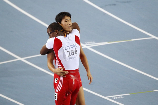 Dayron Robles of Cuba (286) hugs Liu Xiang of China after winning the men's 110 metres hurdles final at the IAAF 2011 World Championships in Daegu Aug 29, 2011. Bittersweet silver brings Liu redemption