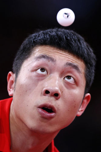 China's Xu Xin eyes the ball as he serves to Steffen Mengel of Germany in their men's singles opening round at the World Team Table Tennis Championships in Paris, May 15, 2013. Top seed Xu Xin reaches second round in Paris tournament
