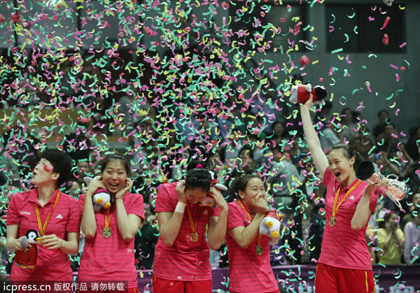 Chinese players celebrate after winning the Beilun International Volleyball Tournament, their first title under Lang Ping's charge, in Ningbo city, Zhejiang province, May 19, 2013. China wins first title under Lang Ping's rein