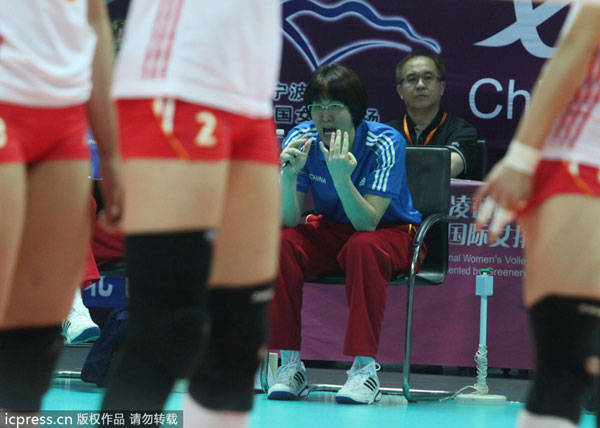 Lang Ping, back, head coach of Chinese national women's volleyball team, gives guidance to players during their Beilun International Volleyball Tournament against Cuba in Ningbo city, Zhejiang province, May 19, 2013. China wins first title under Lang Ping's rein