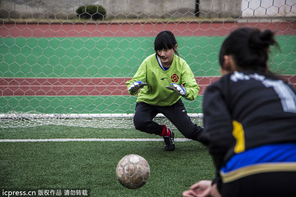 Female soccer players play a match during a training session in Nantong, East China's Jiangsu province, March 16, 2013. Soccer can be girls' sport