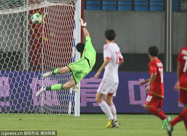 Chinese goalkeeper Geng Xiaofeng concedes a goal during China's 1-5 loss to Thailand in an international friendly in Hefei, Anhui province, June 15, 2013. Soccer national team concedes humiliating defeat