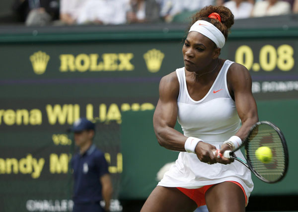 Serena Williams of the U.S. hits a return to Mandy Minella of Luxembourg in their women's singles tennis match at the Wimbledon Tennis Championships, in London June 25, 2013. Djokovic, Williams, and China's Li win openers