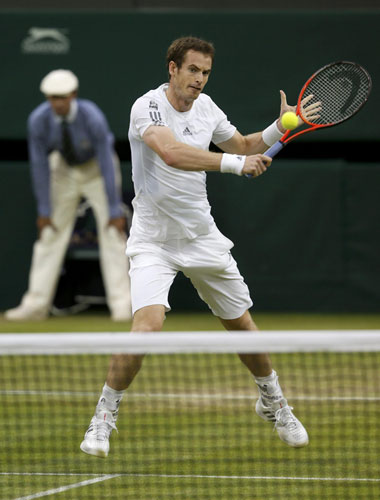 Andy Murray of Britain hits a return to Tommy Robredo of Spain in their men's singles tennis match at the Wimbledon Tennis Championships, in London June 28, 2013. World No 2 Murray cruises to last 16
