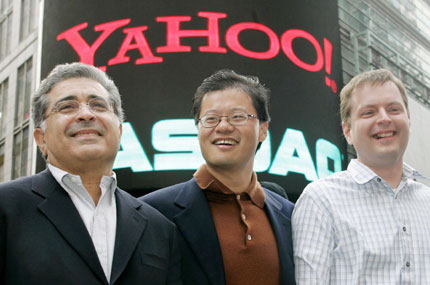 Yahoo! co-founders Jerry Yang (C) and David Filo (R) pose with chief executive Terry Semel in front of the NASDAQ MarketSite in Times Square in New York after ringing the opening bell at NASDAQ in this March 2, 2005 file photo. Following investor pressure for a management CEO Semel is stepping aside and will be replaced as CEO by Yang, Yahoo said on June 18, 2007.