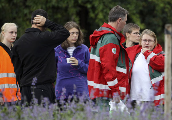 Rescue workers stand outside the hotel, where relatives of victims and survivors of a shooting which took place at a meeting of the youth wing of Norway's ruling Labour Party on Utoeya island have gathered, in Sundvollen July 23, 2011. At least 84 killed by gunman on Utoeya island