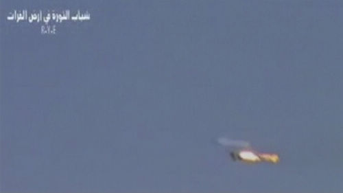 A fighter jet is engulfed in flames in this still picture taken from amateur video said to be shot on August 13, 2012.  Syrians say they hold pilot of downed jet