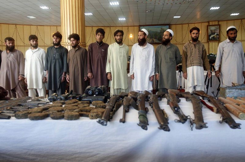 Taliban insurgents and their weapons confiscated by Afghan joint forces during an operation are presented to the media in Jalalabad province, Dec 18, 2012. Images of the day - Dec 18