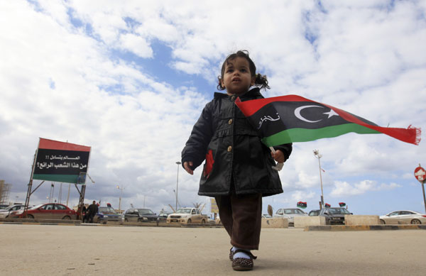 A child waves a Libyan flag, ahead of the second anniversary of the Feb 17 uprising, in Benghazi, on Saturday. Esam Al-Fetori / Reuters Two years after start of revolt, Libyans celebrate
